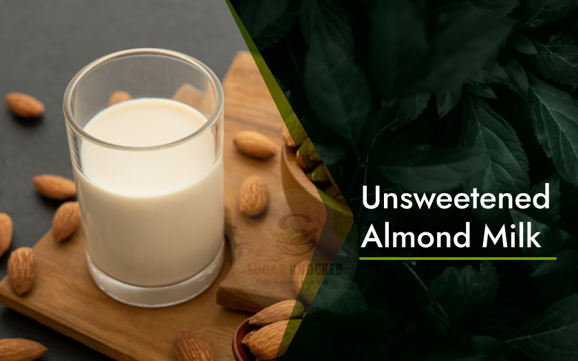 Unsweetened almond milk: a white liquid in a glass with almonds on the side, representing a dairy-free alternative to cow's milk.